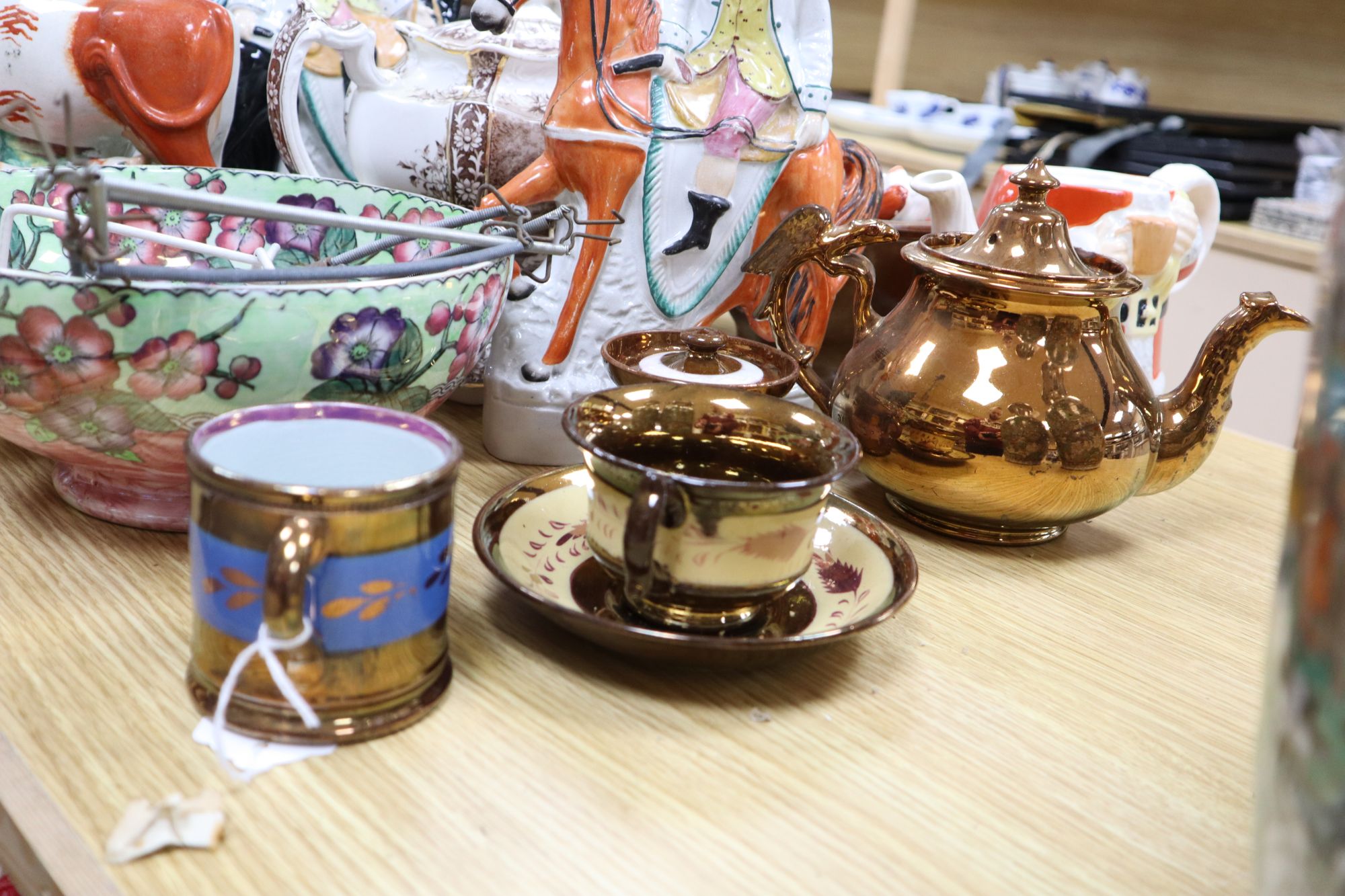 A group of Staffordshire pottery figures, teapots and lustre wares